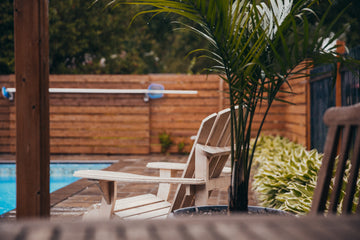 Empty poolside chairs in autumn rain at the end of pool season